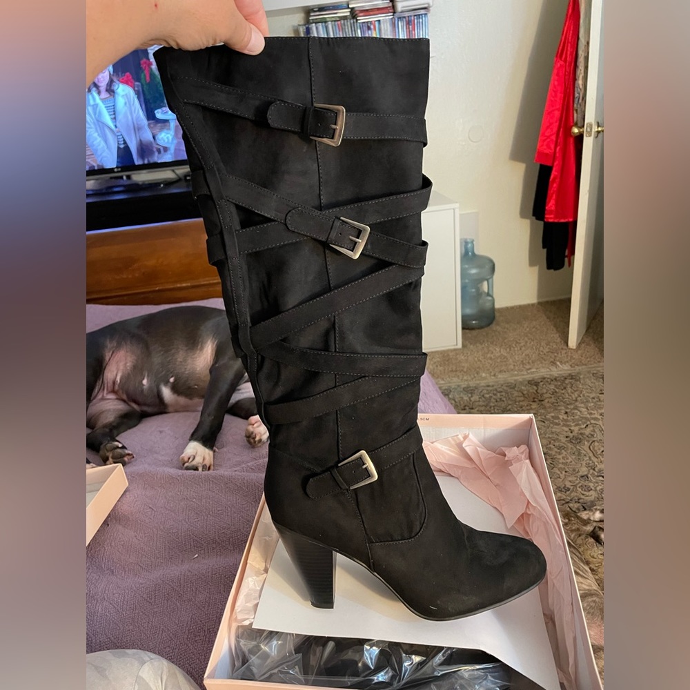 Heeled boots. Black color.  Size 11. Never worn